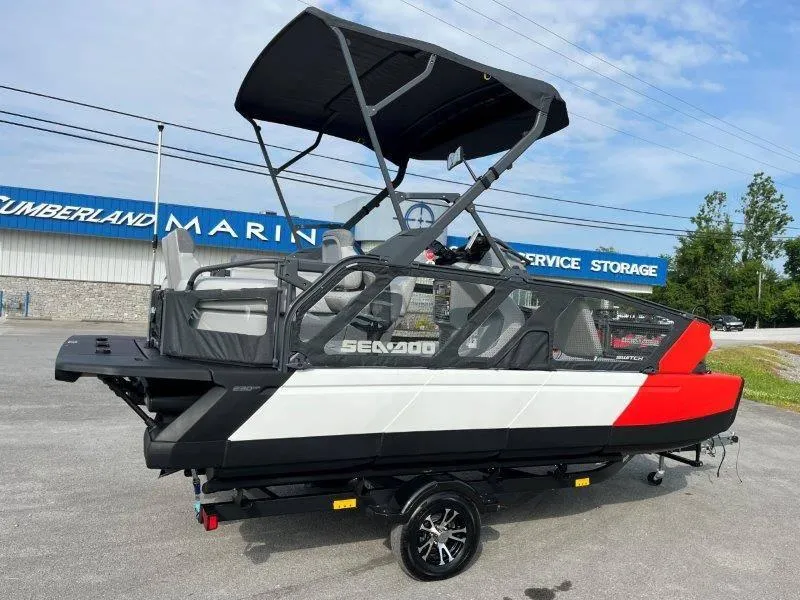 Slide: The Image of 2024 Sea-Doo SWITCH SPORT 18' 230HP boat with canopy, parked at marina. - 6