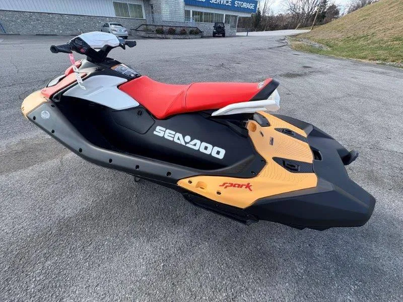 Slide: The Image of 2024 Sea-Doo Spark jet ski with red seat, parked on pavement. - 12