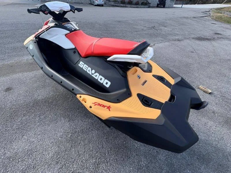 Slide: The Image of 2024 Sea-Doo Spark jet ski with red seat, parked on pavement. - 18