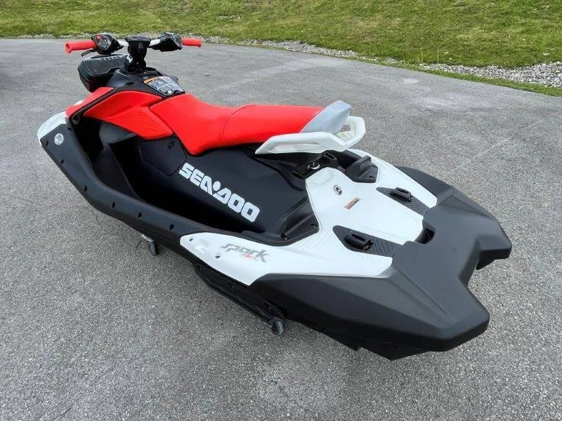 Slide: The Image of 2024 Sea-Doo Spark Trixx jet ski with red seat and black-white design. - 11