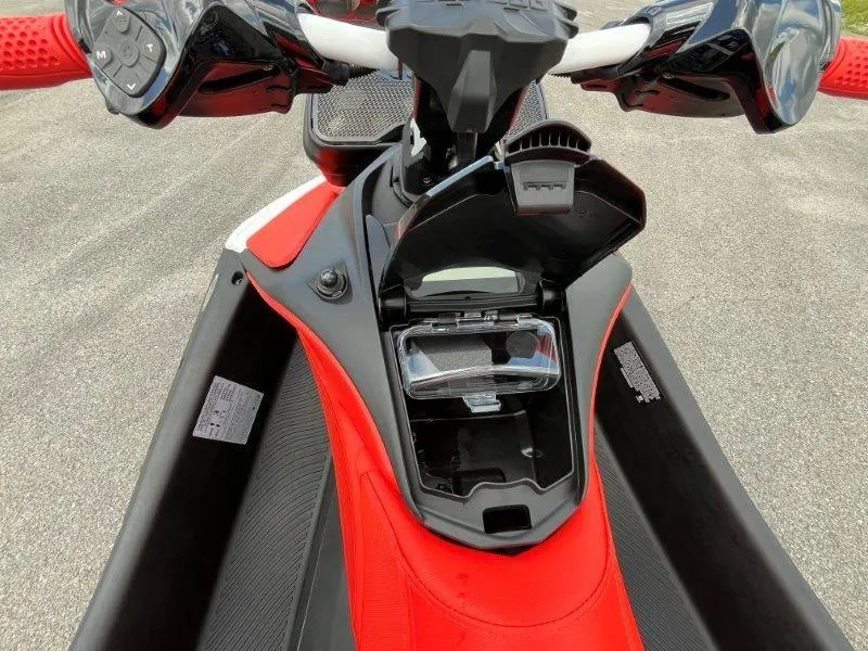 Slide: The Image of 2024 Sea-Doo Spark Trixx dashboard with open storage compartment, showcasing controls and vibrant design. - 26