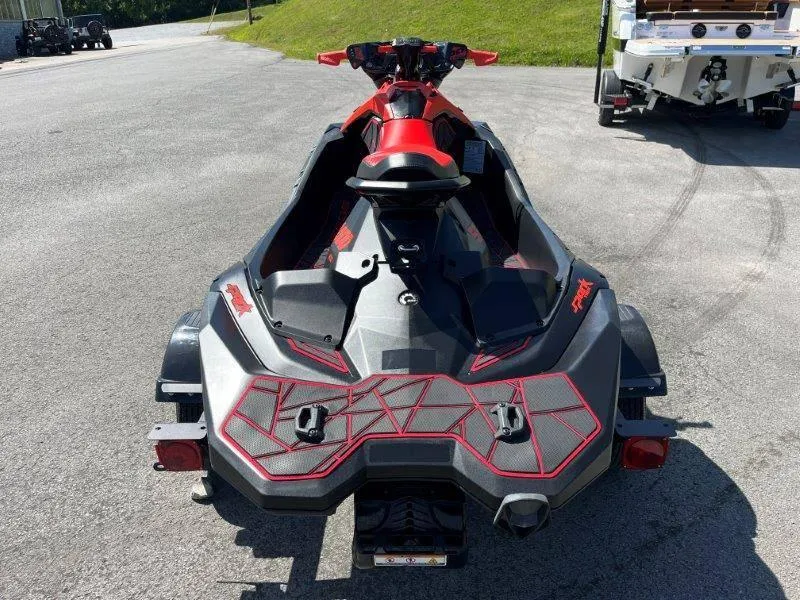 Slide: The Image of 2022 Sea-Doo Spark Trixx 3 Up Sound on trailer, rear view, parked outdoors. - 11
