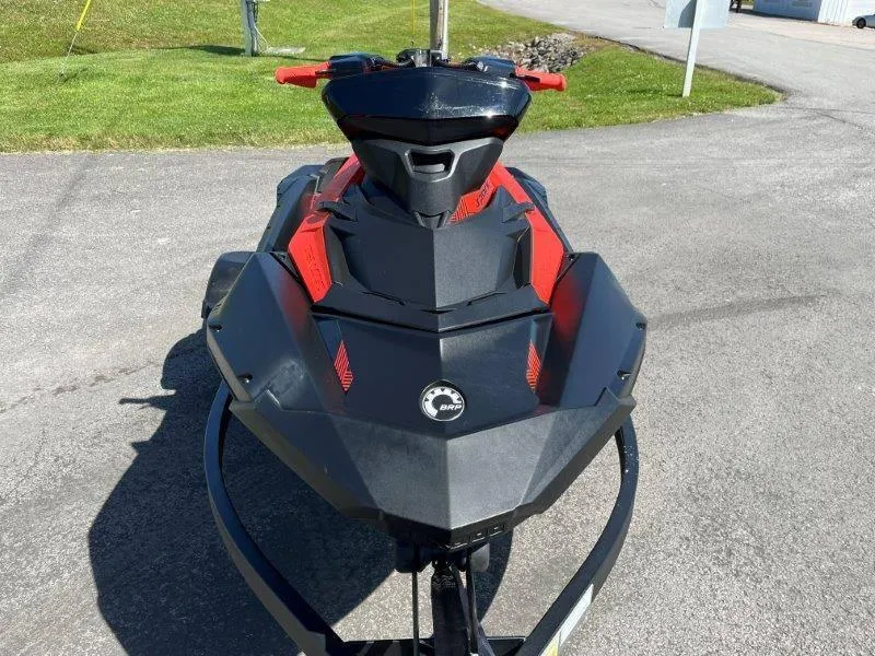 Slide: The Image of 2022 Sea-Doo Spark Trixx 3 Up Sound, black and red, parked on pavement. - 15