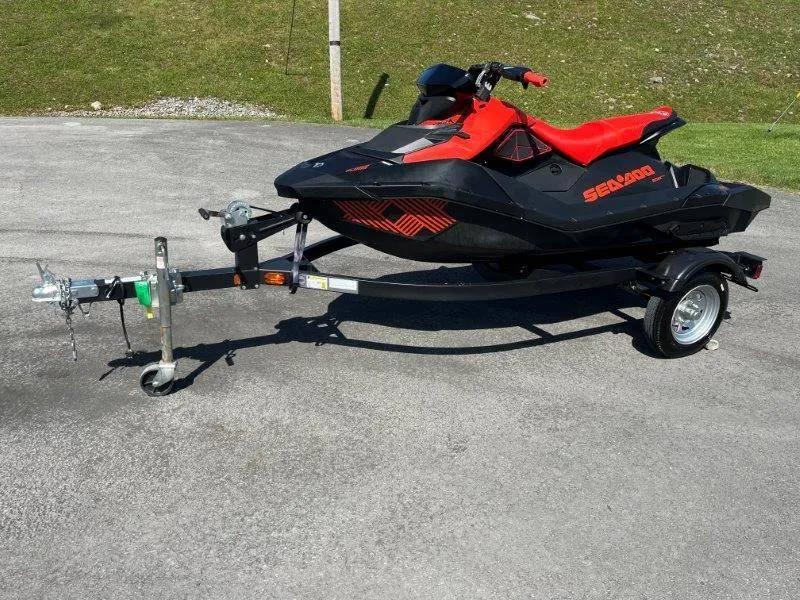 Slide: The Image of 2022 Sea-Doo Spark Trixx 3 Up Sound on trailer, parked on pavement. - 16