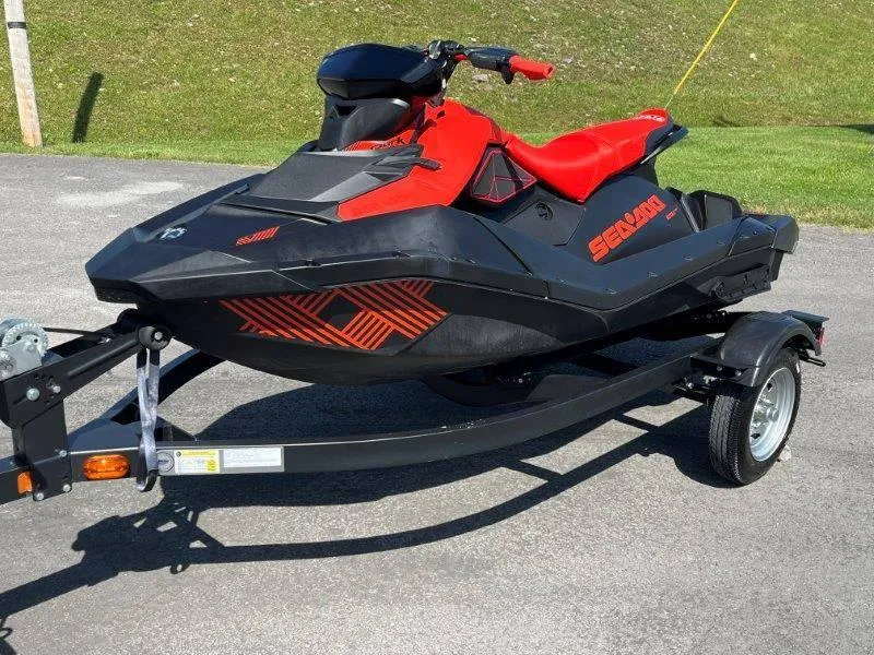 Slide: The Image of 2022 Sea-Doo Spark Trixx 3 Up Sound on trailer, red and black design. - 18