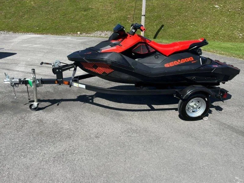 Slide: The Image of 2022 Sea-Doo Spark Trixx 3 Up Sound on trailer, parked on pavement. - 19