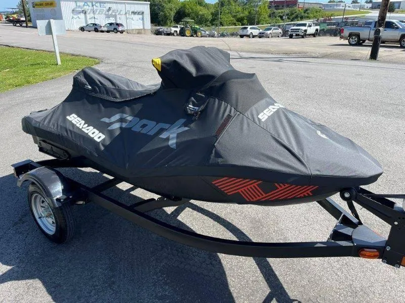 Slide: The Image of 2022 Sea-Doo Spark Trixx 3 Up Sound on trailer, covered, in parking lot. - 25