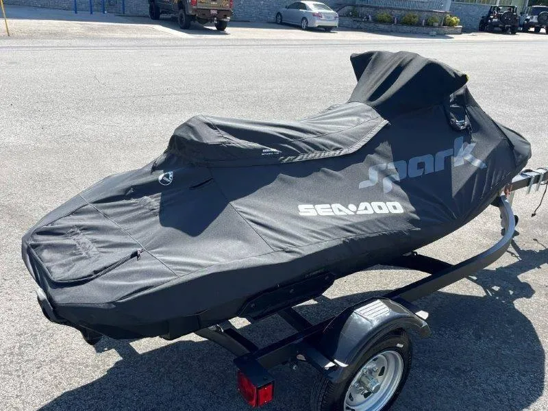 Slide: The Image of 2022 Sea-Doo Spark Trixx 3 Up Sound covered on trailer in parking lot. - 27