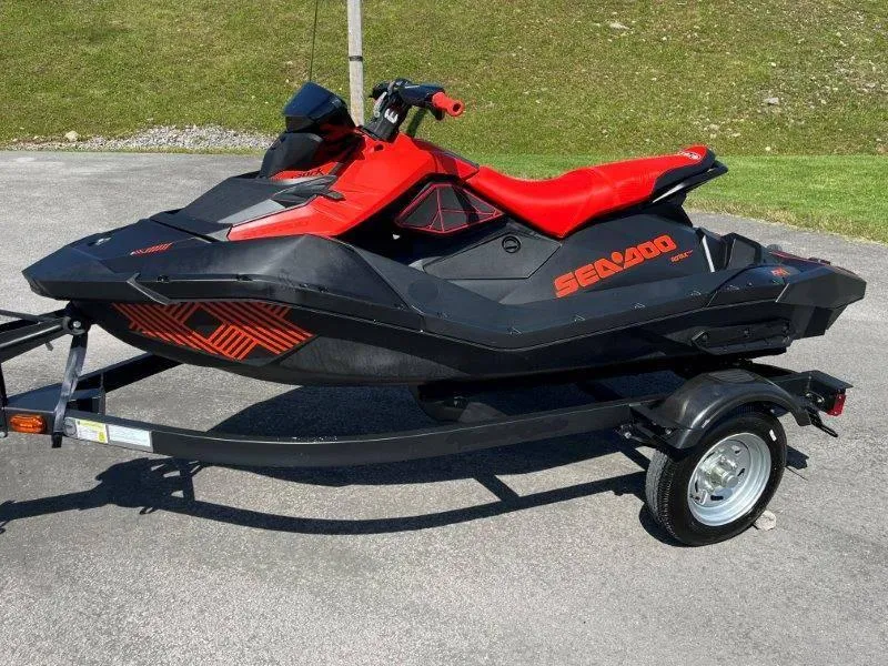 Slide: The Image of 2022 Sea-Doo Spark Trixx 3 Up Sound on trailer, red and black design. - 3