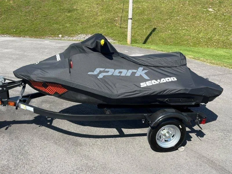 Slide: The Image of 2022 Sea-Doo Spark Trixx 3 Up Sound covered on trailer, parked outdoors. - 30