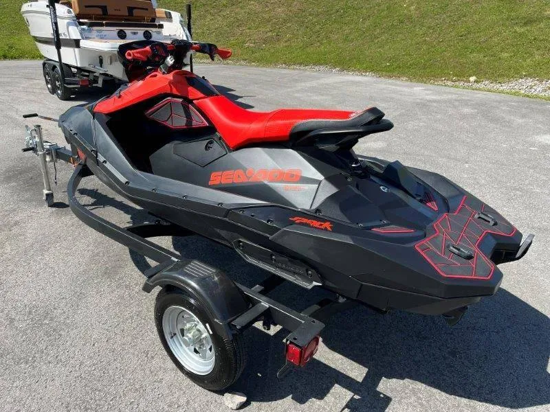 Slide: The Image of 2022 Sea-Doo Spark Trixx 3 Up Sound on trailer, black and red design. - 4