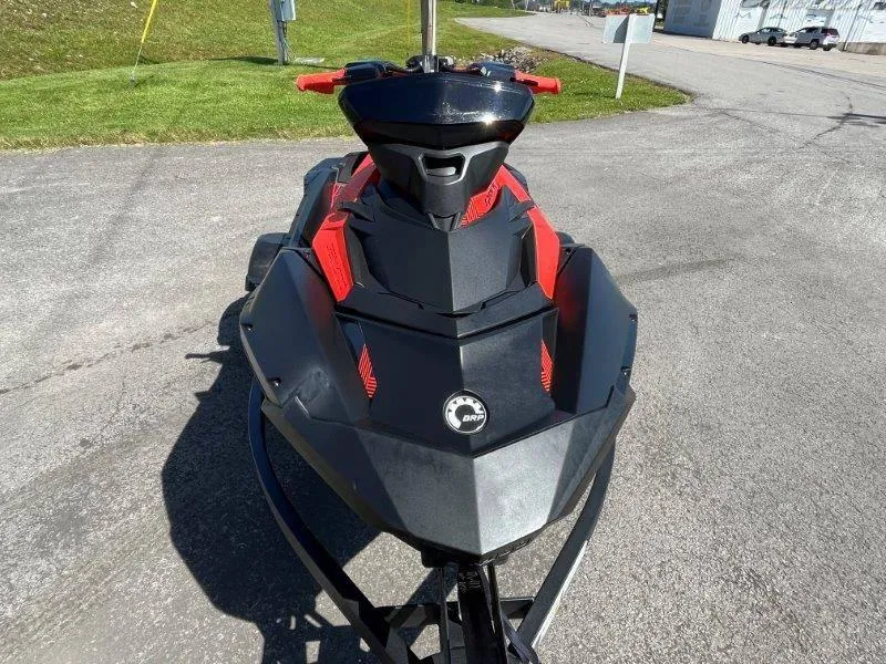 Slide: The Image of 2022 Sea-Doo Spark Trixx 3 Up Sound, black and red, parked on pavement. - 5