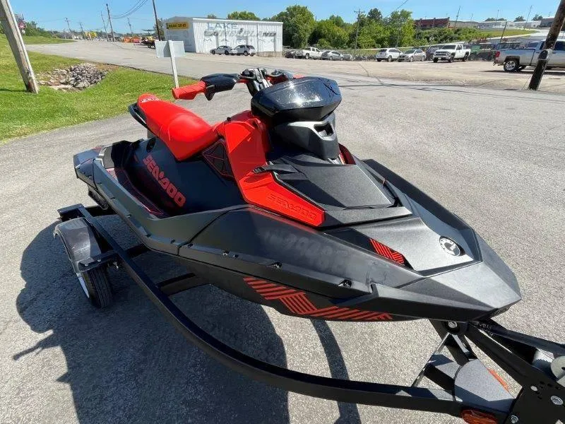 Slide: The Image of 2022 Sea-Doo Spark Trixx 3 Up Sound on trailer, vibrant red and black design. - 7