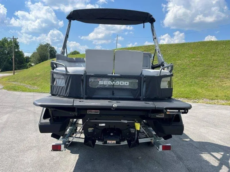Slide: The Image of 2024 Sea-Doo Switch Cruise 18' 230hp pontoon boat, rear view, parked outdoors. - 42