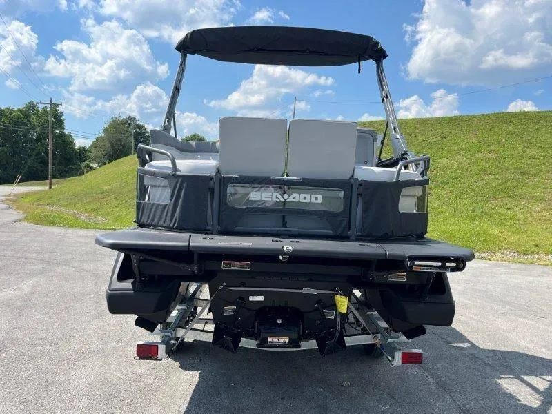 Slide: The Image of 2024 Sea-Doo Switch Cruise 18' 230hp boat, rear view, parked outdoors under blue sky. - 45