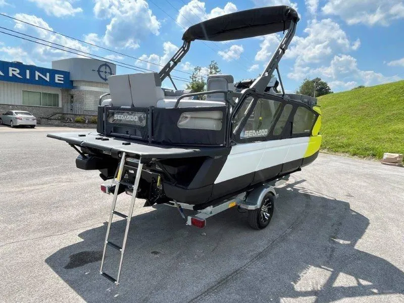 Slide: The Image of 2024 Sea-Doo Switch Cruise 18' 230hp boat on trailer, parked outdoors under blue sky. - 47
