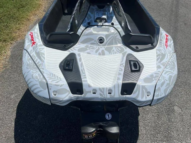 Slide: The Image of 2024 Sea-Doo Spark 1UP Trixx 90 Sound, rear view on pavement. - 12