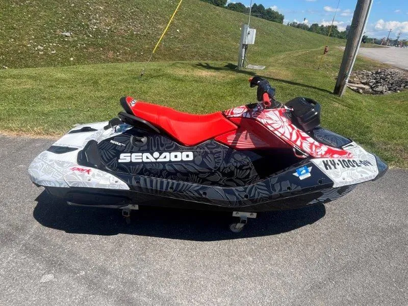 Slide: The Image of 2024 Sea-Doo Spark 1UP Trixx 90 Sound jet ski with vibrant red seat. - 14