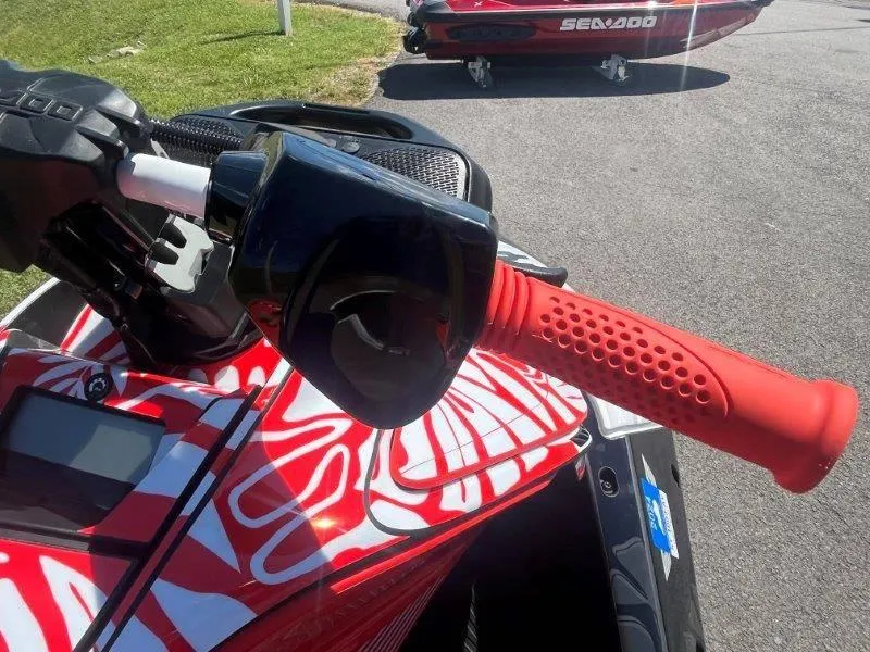 Slide: The Image of 2024 Sea-Doo Spark 1UP Trixx 90 Sound, vibrant red handlebar detail. - 31