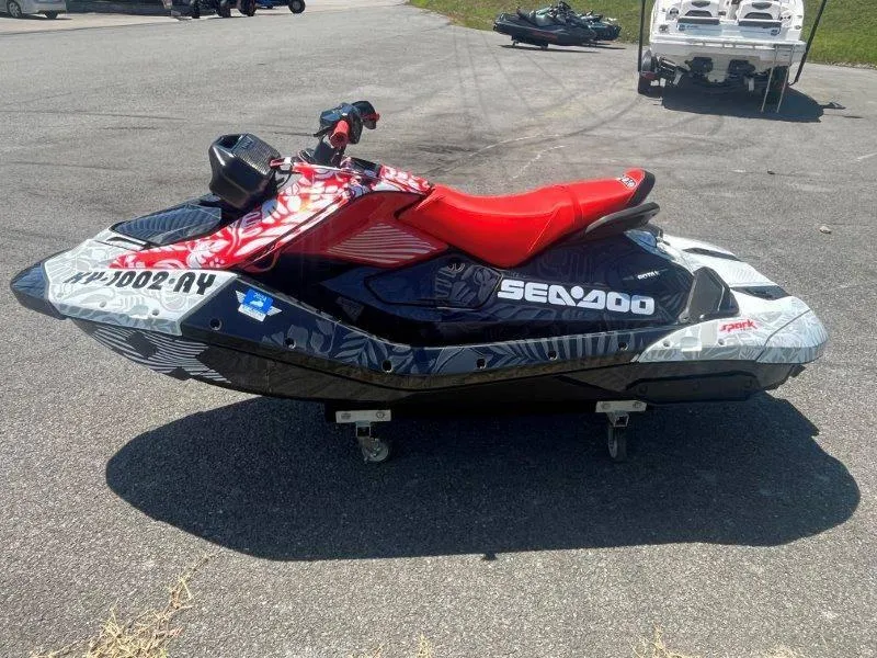 Slide: The Image of 2024 Sea-Doo Spark 1UP Trixx 90 Sound jet ski with red seat on display. - 5