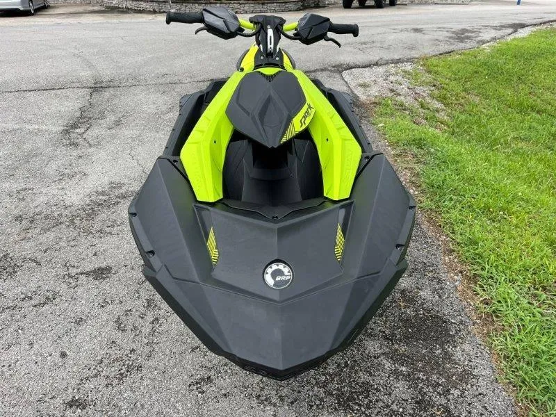 Slide: The Image of 2023 Sea-Doo SPARK TRIXX 2up jet ski, black and yellow, parked on pavement. - 20