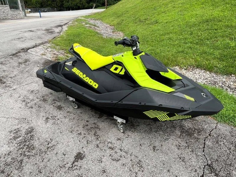 Slide: The Image of 2023 Sea-Doo SPARK TRIXX 2up jet ski in vibrant green and black on pavement. - 22