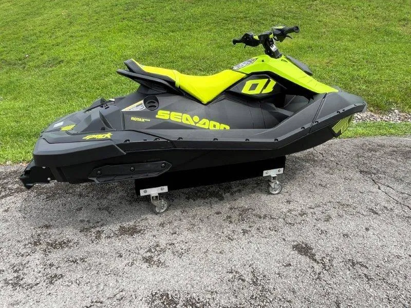 Slide: The Image of 2023 Sea-Doo SPARK TRIXX 2up jet ski on pavement, vibrant yellow and black design. - 24