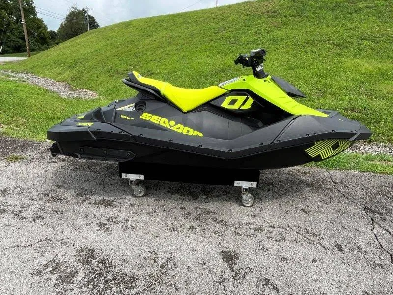 Slide: The Image of 2023 Sea-Doo SPARK TRIXX 2up jet ski on pavement, vibrant yellow and black design. - 29