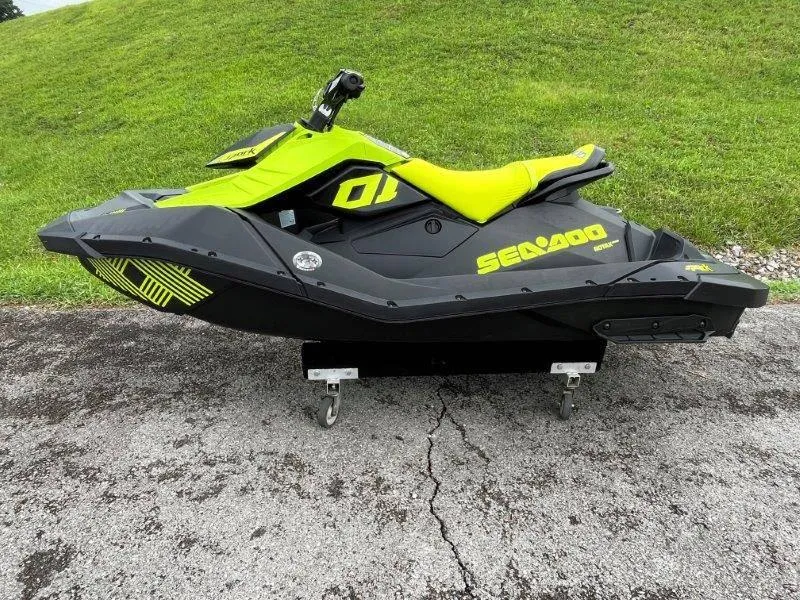 Slide: The Image of 2023 Sea-Doo SPARK TRIXX 2up jet ski on pavement, vibrant green and black design. - 3