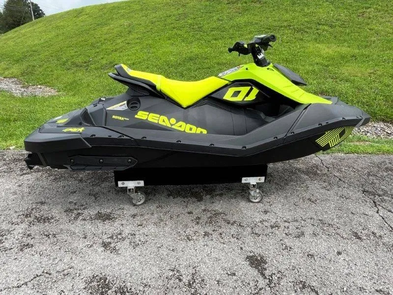 Slide: The Image of 2023 Sea-Doo SPARK TRIXX 2up jet ski on pavement, vibrant green and black design. - 30