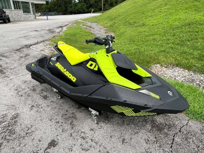Slide: The Image of 2023 Sea-Doo SPARK TRIXX 2up jet ski, vibrant yellow and black design, parked on pavement. - 32