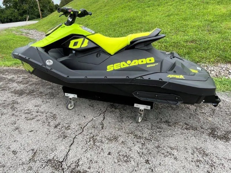 Slide: The Image of 2023 Sea-Doo SPARK TRIXX 2up jet ski on pavement, vibrant green and black design. - 4