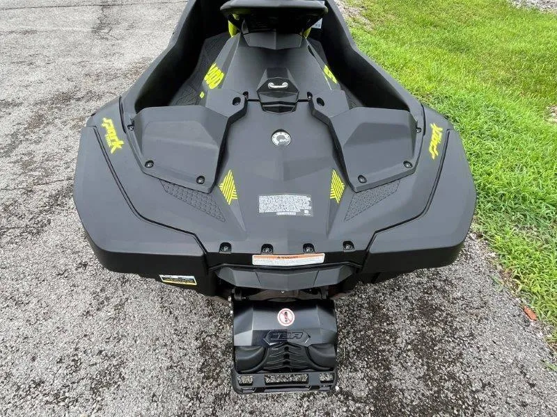Slide: The Image of 2023 Sea-Doo SPARK TRIXX 2up jet ski on pavement, rear view. - 6