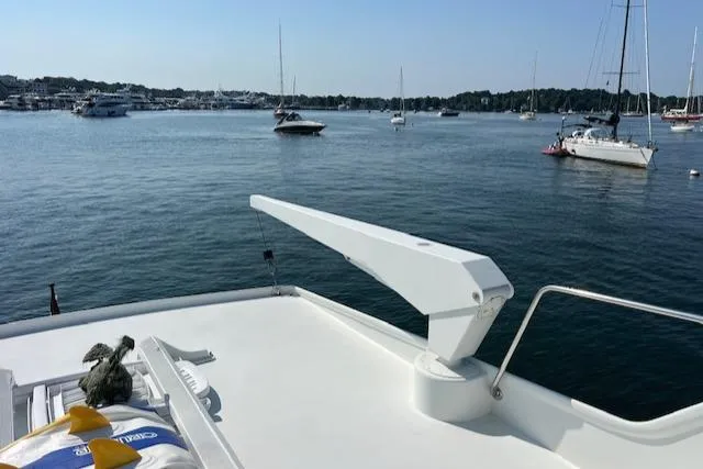 Slide: The Image of 1980 Huckins Sports Cruiser on calm waters with other boats in the background. - 16