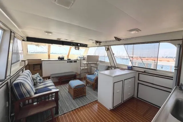 Slide: The Image of Interior of 1980 Huckins Sports Cruiser with wood flooring and nautical decor. - 20