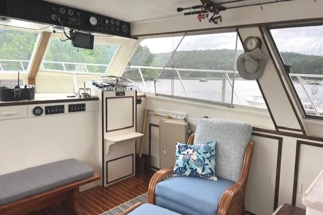 Slide: The Image of Interior of a 1980 Huckins Sports Cruiser with comfortable seating and scenic views. - 22