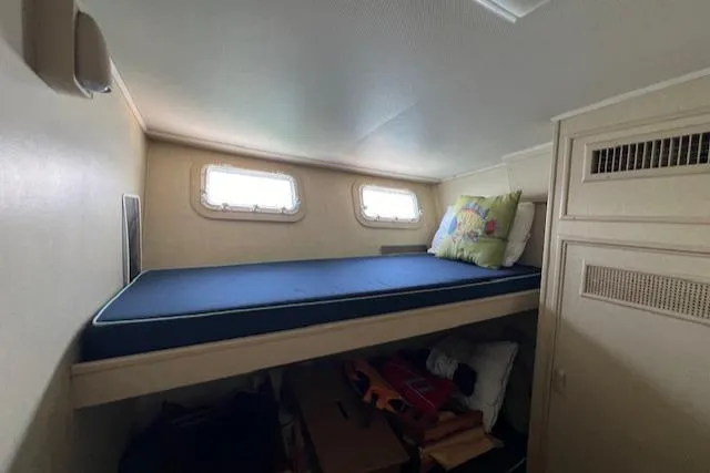 Slide: The Image of 1980 Huckins Sports Cruiser cabin with bunk bed and storage. - 27