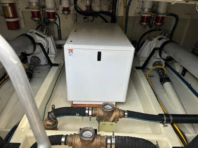 Slide: The Image of Engine room of 1980 Huckins Sports Cruiser with mechanical components and piping. - 32