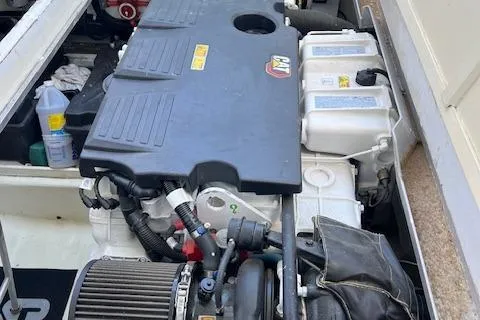 Slide: The Image of Engine compartment of a 1980 Huckins Sports Cruiser, showcasing mechanical components and storage area. - 33