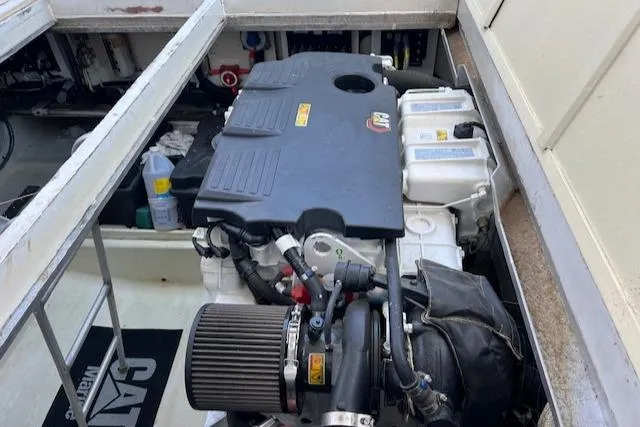 Slide: The Image of Engine compartment of a 1980 Huckins Sports Cruiser, showcasing detailed mechanical components. - 34