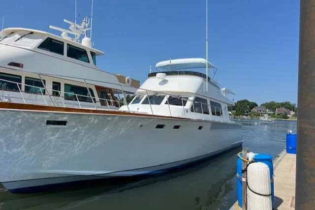 Slide: The Image of 1980 Huckins Sports Cruiser docked at marina on a sunny day. - 7