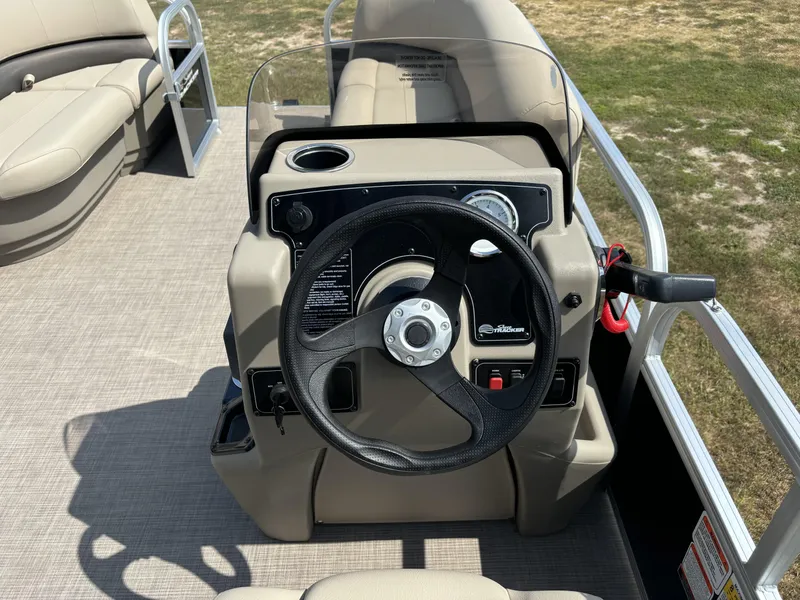 Slide: The Image of 2025 Sun Tracker Bass Buggy 16 XL Select steering console with beige seating. - 13