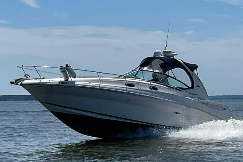 Slide: The Image of 2007 Sea Ray 320 Sundancer cruising on open water under a clear sky. - 0