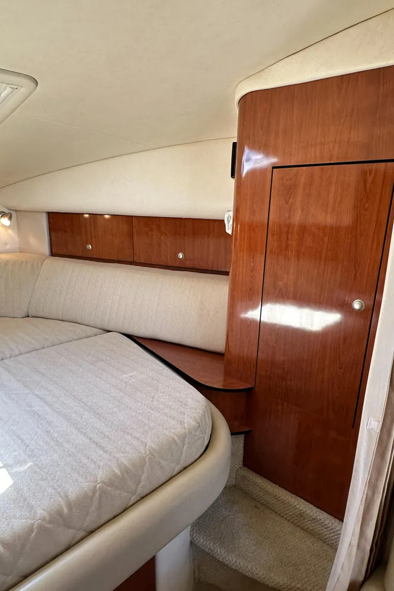 Slide: The Image of Interior of 2007 Sea Ray 320 Sundancer with wood cabinetry and upholstered seating. - 29