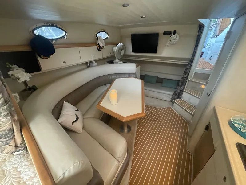 Slide: The Image of Interior of 1997 Wellcraft 3200 Martinique boat with seating, table, and TV. - 10