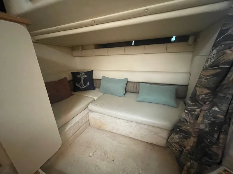 Slide: The Image of Interior of 1997 Wellcraft 3200 Martinique boat with cozy seating and decorative pillows. - 11