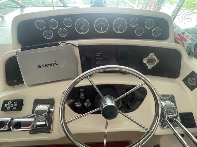 Slide: The Image of 1997 Wellcraft 3200 Martinique helm with Garmin navigation system and steering wheel. - 3