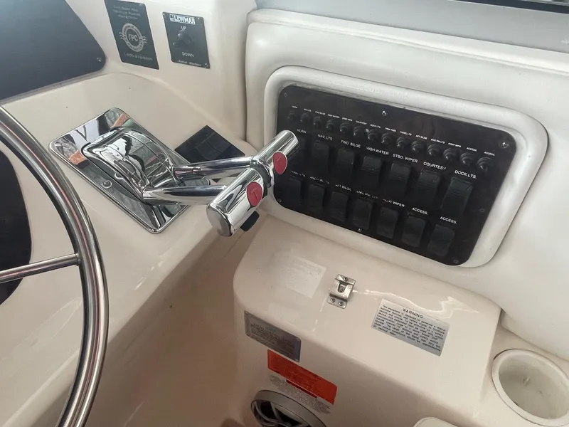 Slide: The Image of Control panel of a 1997 Wellcraft 3200 Martinique boat with steering wheel and switches. - 4
