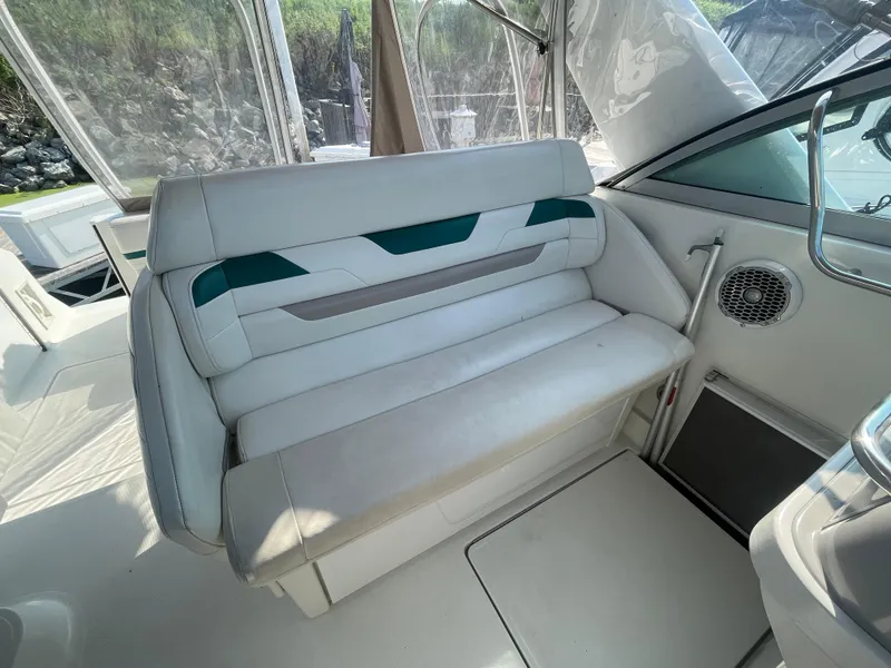 Slide: The Image of 1999 Formula 34 PC boat interior with white seating and green accents. - 13