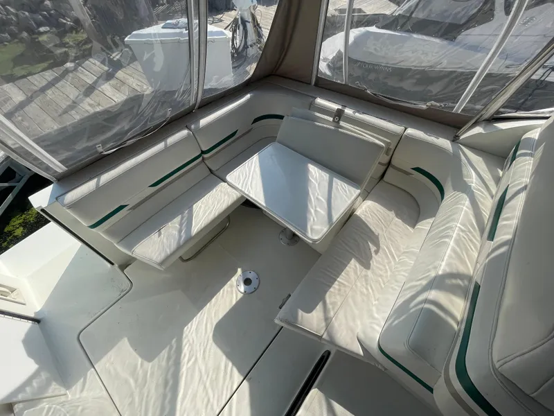 Slide: The Image of 1999 Formula 34 PC boat interior with white seating and table. - 14